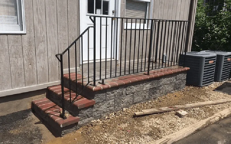 Brick and masonry entry steps with metal railings